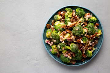Homemade Broccoli Bacon Salad on a Plate on a gray background, top view. Flat lay, overhead, from above. Copy space.