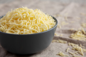 Shredded Mozzarella Cheese in a Bowl, side view.
