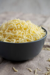 Shredded Mozzarella Cheese in a Bowl, side view.