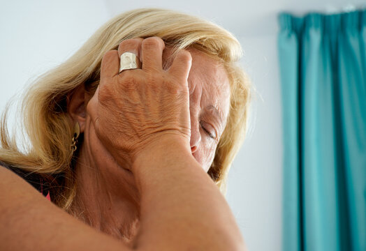 Authentic Woman Unhappy And Sad With Her Hands On Her Face, Sitting On The Floor. Psychological And Mental Problems. Mental Health