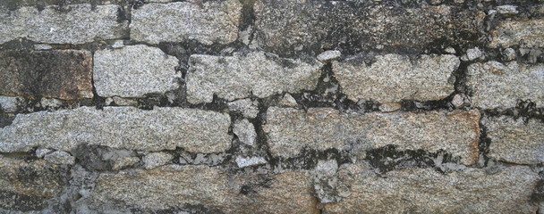 Stone wall texture background of grey brick stones.