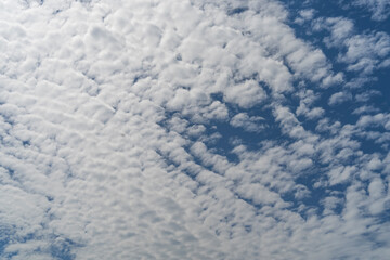 blue sky background with tiny clouds