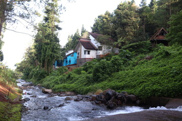 River with villa in highland background