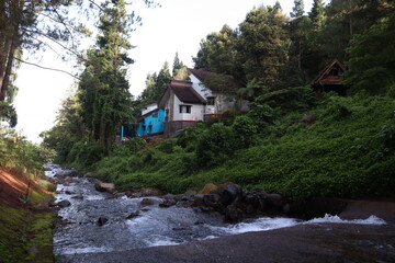 River with villa in highland background