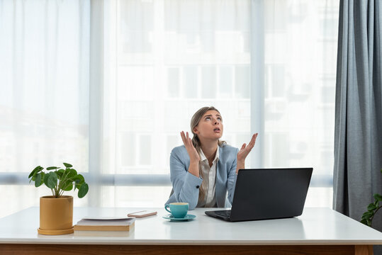 Young Frustrated Business Woman Office Worker Trying To Concentrate For Her Work While She Sitting In The Company Office With Old Laptop Computer And Slow Internet Connection.