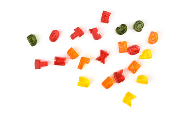 multi-colored marmalade (jelly, gelatin) yellow, red, orange, green in the form of the English alphabet (letters) on a white background