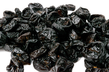 a handful of dried prunes on a white background