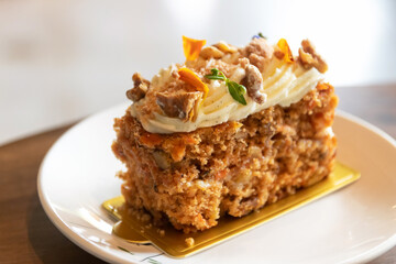 Carrot cake with walnuts, prunes and dried apricots with little edible flower.