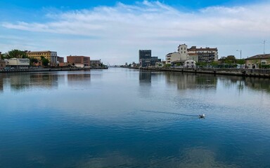 Beautiful view of buildings reflecting on a water in Darsena, Ravenna, Italy