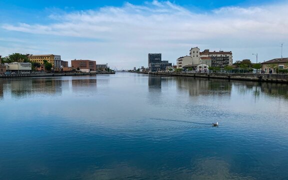 Beautiful view of buildings reflecting on a water in Darsena, Ravenna, Italy