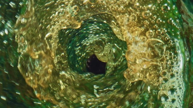 Hoppy ipa bubbling glassware top view. lcohol fizzy beverage rotating in goblet