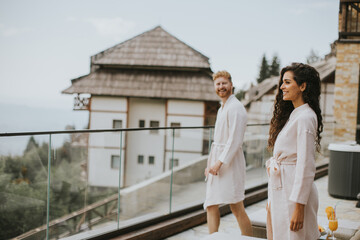 Young couple relaxing on  the outdoor terrace