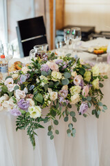 A beautiful vase of flowers on a table in a luxury restaurant. Wedding decorations