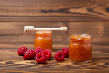 Honey in a glass jar. Raspberry and blueberry honey jam. Remedy for colds and respiratory diseases. Organic product of a vegetarian diet. copy space. copy space