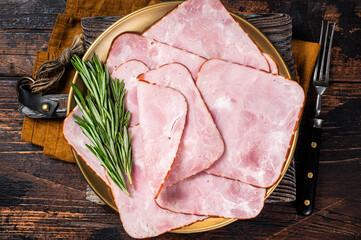 Square Sliced pork meat ham on plate. Wooden background. Top view