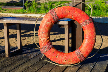 Red lifebuoy on the beach in summer