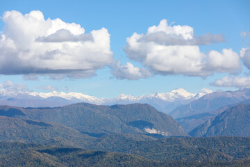 Mountains and snow peaks under beautiful clouds. The Caucasian ridge.