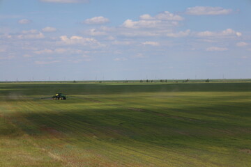 A special tractor treats the field with flax. View from the top.