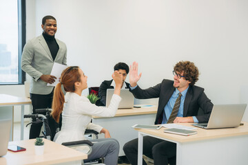 Obraz premium Businesswoman holding a meeting, conference, and conversation with his team while seated in a wheelchair at the workplace.