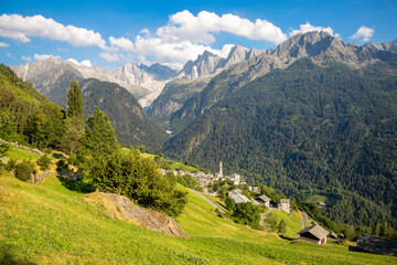 Fototapeta na wymiar The Soglio village uder the alps meadows and Piz Badile, Pizzo Cengalo, and Sciora peaks in the Bregaglia range - Switzerland.