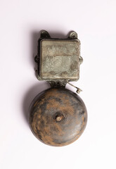 Rusty vintage electric alarm on white. The concept of old technologies. 