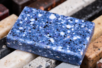 Porcelain blue stoneware square samples laid on kitchen countertop examples of future kitchen...