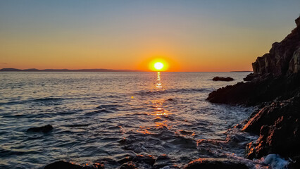 Obraz premium Panoramic view of coastline during sunset near Karydi beach, Vourvourou, Sithonia, Chalkidiki (Halkidiki), Greece, Europe. Vacation summer at Aegean Mediterranean Sea. Romantic atmosphere. Seascape