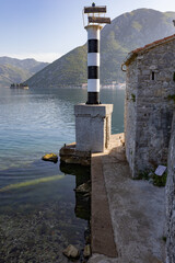 Fototapeta na wymiar Old house and lighthouse Kotor Bay Montenegro