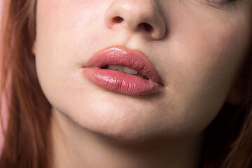 Naklejka premium Women's lips close up. Close-up portrait of a woman