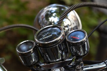 Selective focus shot of a silver motorcycle instrument panel cluster