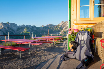 Backback with gear sits at the front of a mountainside Hutte in Eppenzellerland Canton of the Swiss Alps