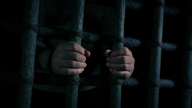 Dirty Hands Holding Bars In The Dark
