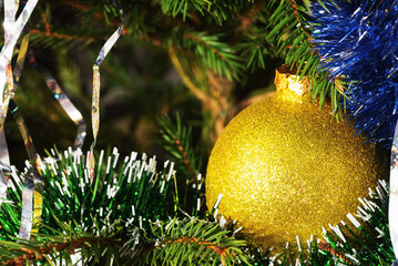 Yellow ball on a festive tree with copy space