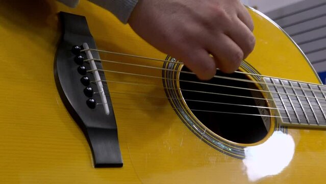 Close-up of playing an acoustic guitar