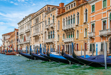 Gondolas moored on Grand Canal at traditional Venetian buildings, Venice, Italy.