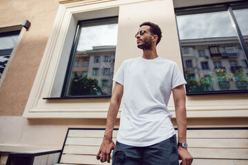 Stylish african american man in white blank t-shirt and sunglasses. Mock-up.