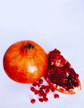 Pomegranate (Punica granatum) fruit whole and cut red anaar rodie nar melograno anor grenadefruit anar delima granateple granatapfel frantafruit shiliufruit dalimafruit view image photo
