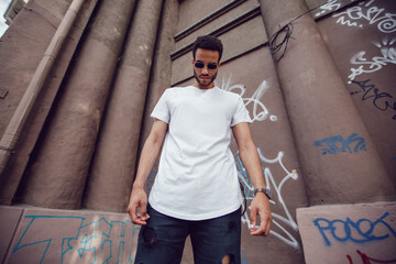 Stylish african american man in white blank t-shirt and sunglasses. Mock-up.