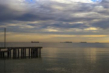 Fototapeta premium The end of the pier against the background of the sea at sunrise in Gdynia, Poland