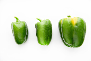 Juicy green and yellow pepper fruits on a white background. Beautiful shiny and delicious pepper.
