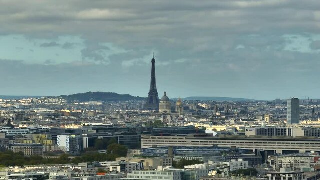 Aerial view of the roofs of buildings, streets and avenues with car traffic, modern and classical architecture. Moving aerial drone shot