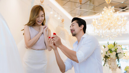 Will You Marry Me Concept. young girl happy and surprise. man making a proposal while giving an engagement ring for his lovely girl 