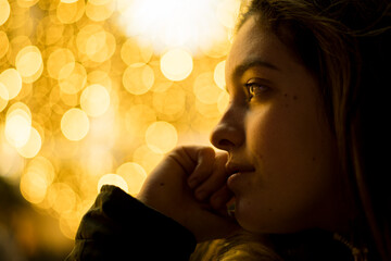 portrait of a beautiful young woman with Christmas lights