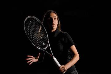 awesome beautiful portrait of caucasian woman with brown hair in black tennis uniform with tennis racket