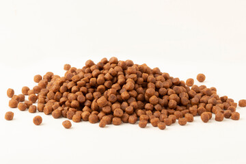 Pile of dry pet food isolated on white background.