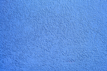 Fototapeta na wymiar Background of blue concrete wall. Decorative embossed concrete and glue plaster. Blue plastered wall. Plaster textured background. Blurred photo