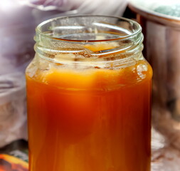 Jar with natural honey close-up in summer