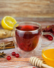 Seasonal healthy tea made from red berries with lemon, ginger and honey. Close-up. Selective focus.