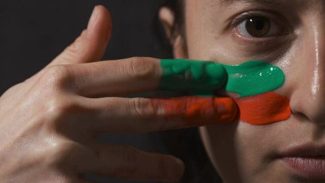 Supporter Painting Face. Football Fan Preparing for the Match. Colored Face with Flag Colors Red and Green. Slow Motion 4K Prores 422