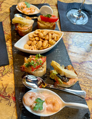 aperitif with seafood, nuts, and canapés